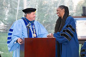 President Miaoulis shakes hands with honorary degree recipient Dr. Nicole Alexander-Scott at commencement